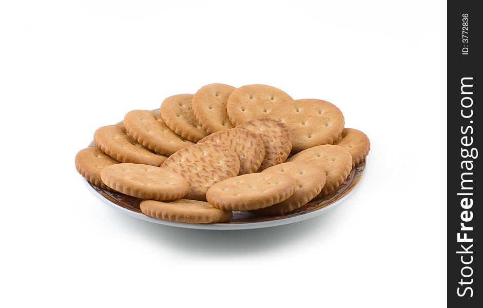A plate of salty crackers isolated on white