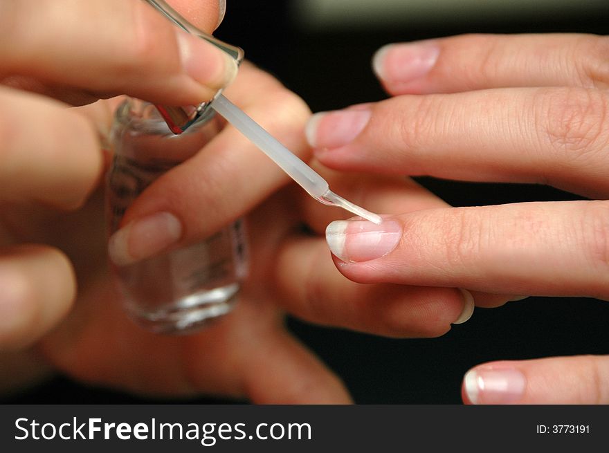 Woman Glossing Nails