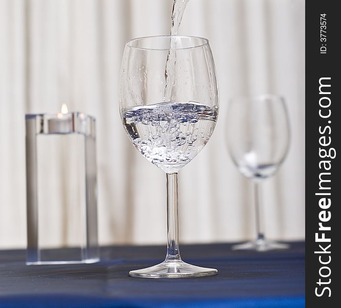 Pouring water in a glass (restaurant scene). Pouring water in a glass (restaurant scene).