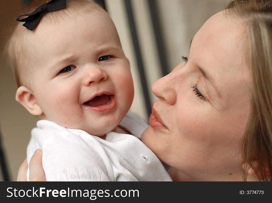 Attractive young woman showing off her pretty little baby girl. Attractive young woman showing off her pretty little baby girl