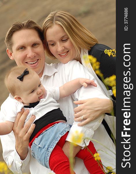 Very happy young family looking adorable while hanging out at the park. Very happy young family looking adorable while hanging out at the park