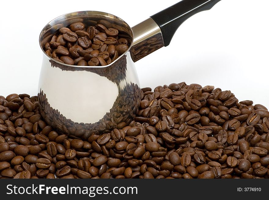 A few coffee beans with a coffee boiler. A few coffee beans with a coffee boiler