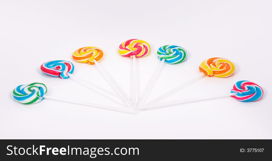 Twirl lollipop candies over a white background