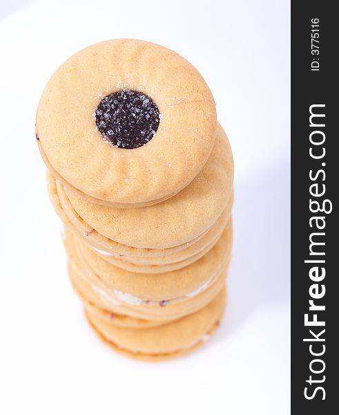 Stack of sweet biscuits over a white background