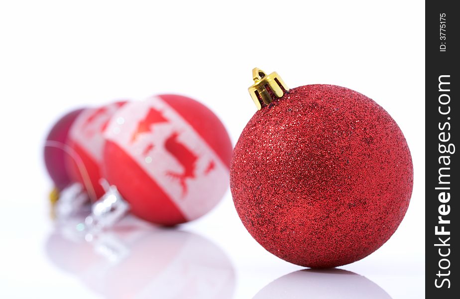 Red christmas balls over a white background