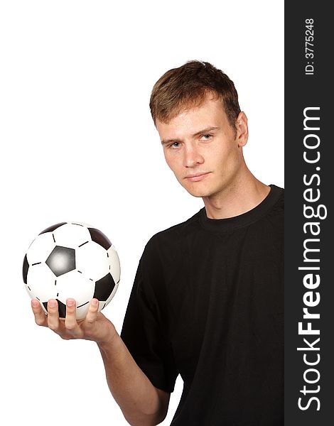 Football player holding soccer ball in one hand