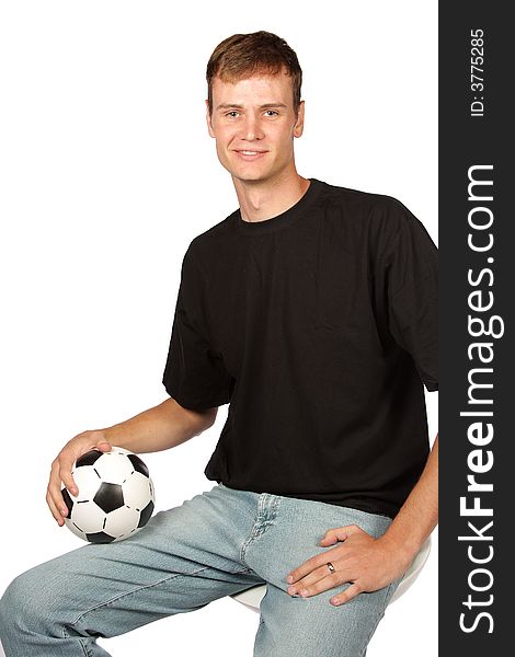Football player in denim with ball in lap. Football player in denim with ball in lap