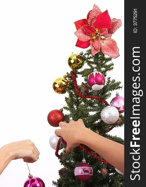 Decorating a christmas tree over a white background