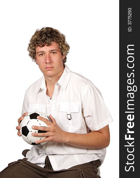 Soccer player sitting with football in his hands. Soccer player sitting with football in his hands