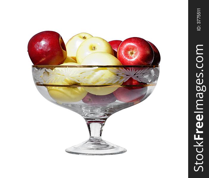 A glass vase with yellow and red apples. A glass vase with yellow and red apples