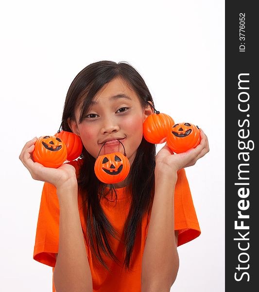 A young girl showing her pumpkins over a white background