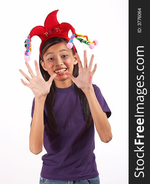A young girl wearing a funny headband over a white background. A young girl wearing a funny headband over a white background