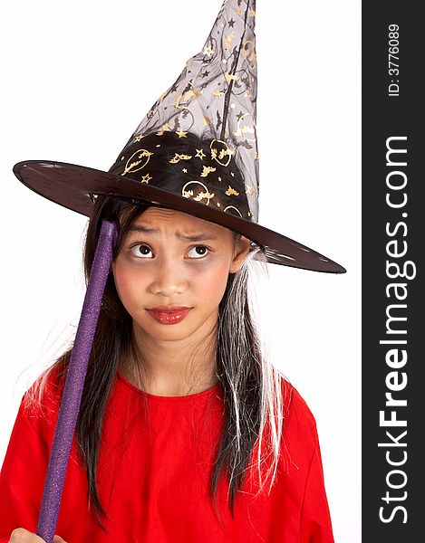 A young girl dressed in a witch costume