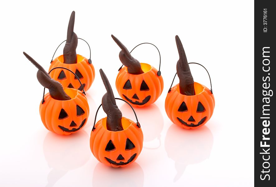Halloween pumpkins with creepy nails inside over a white background