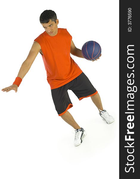 Young man playing basketball. He's dressed orange T-shirt. White background, front view. Young man playing basketball. He's dressed orange T-shirt. White background, front view.