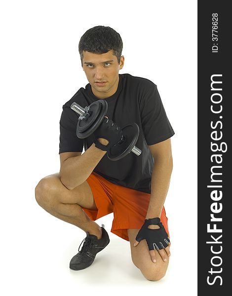 Young man exercising with dumbbell. Isolated on white background. Looking at camera, front view.