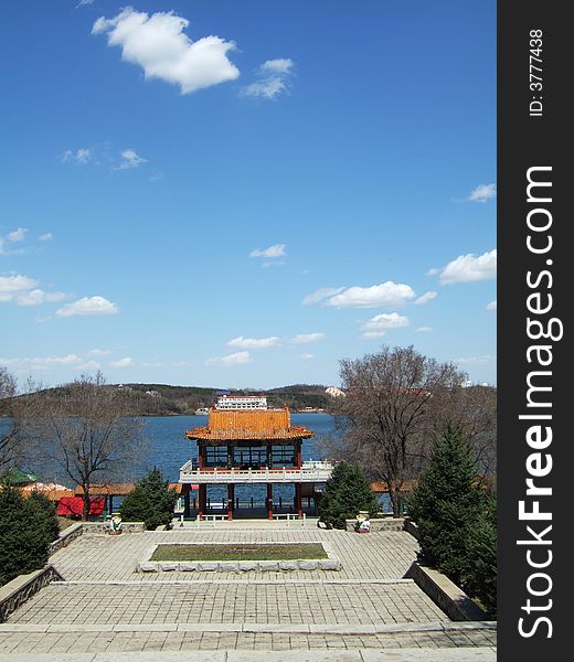 Waterfront of a lake with the blue sky and white cloud