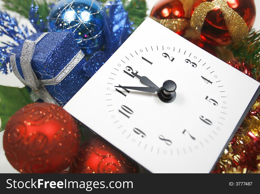 Waiting for midnight - view of a clock against the background of christmas/new year's ornaments