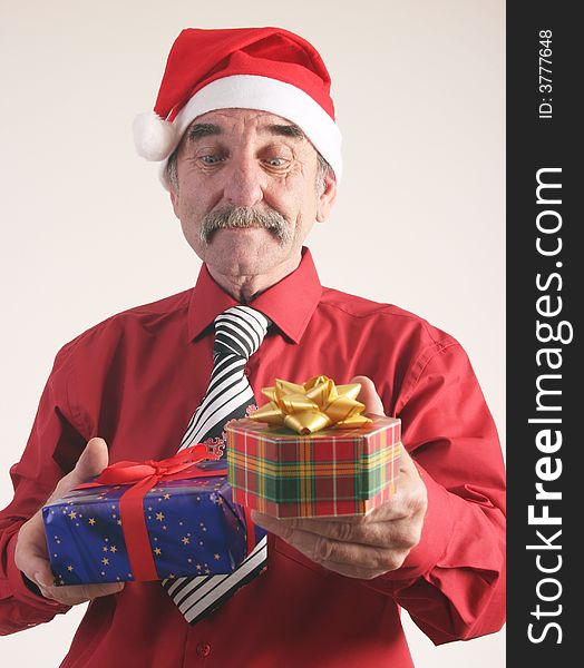 Businessman with Christmas gift and Santa Claus hat. Businessman with Christmas gift and Santa Claus hat.