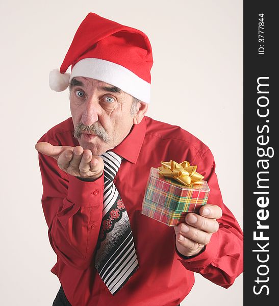 Businessman with Christmas gift and Santa Claus hat. Businessman with Christmas gift and Santa Claus hat.
