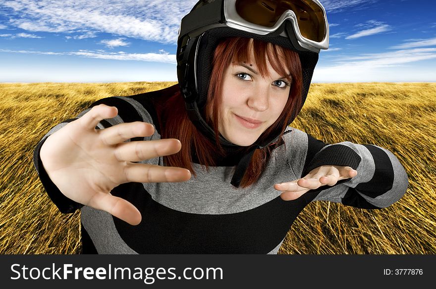 Cute girl preparing to take of on a blue sky and autumnish pasture, high grass. Studio shot, composite. Cute girl preparing to take of on a blue sky and autumnish pasture, high grass. Studio shot, composite.