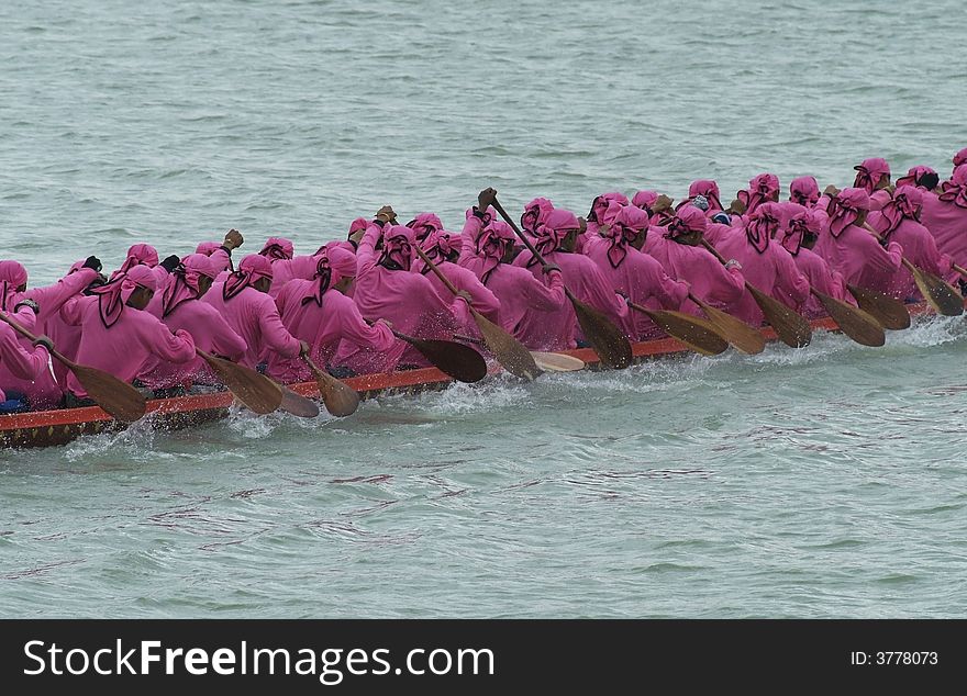 Paddlers in a longboat during a race in Thailand. Paddlers in a longboat during a race in Thailand