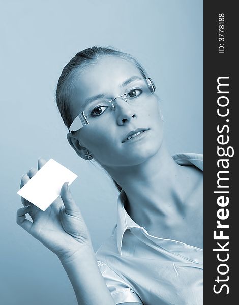 Business portrait of a young and successful woman with a businesscard in her hand. Business portrait of a young and successful woman with a businesscard in her hand