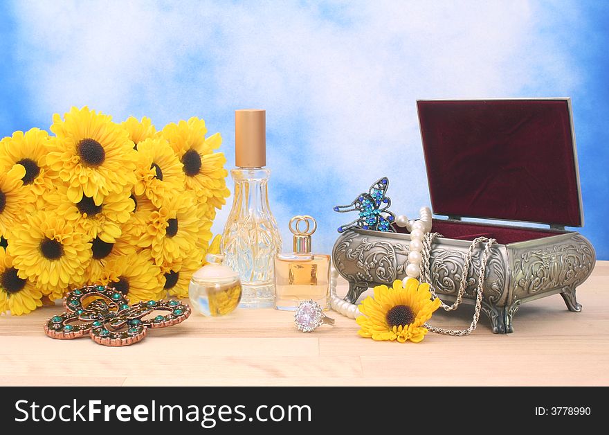 Jewelry and Perfume on Wood With Blue Sky Background. Jewelry and Perfume on Wood With Blue Sky Background