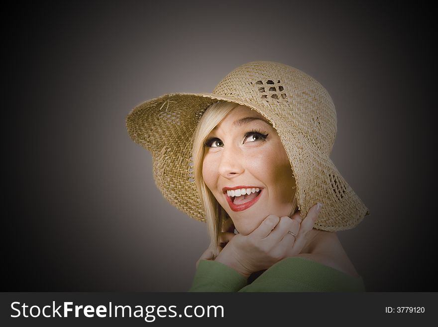 Blonde Model in straw hat under spotlight. Blonde Model in straw hat under spotlight