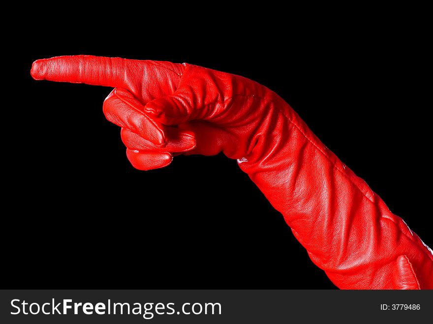 Hand in red glove on the black background showing the left order