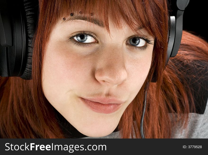 Cute redhead girl looking seductively at camera, smiling, and listening to music on headphones.

Studio shot. Cute redhead girl looking seductively at camera, smiling, and listening to music on headphones.

Studio shot.