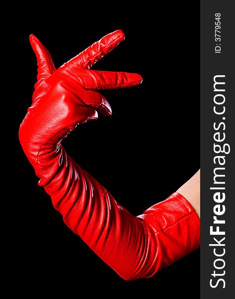 Hand in red glove on the black background counting three. Hand in red glove on the black background counting three