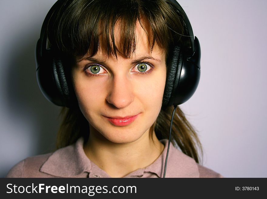 Woman with headphones is listening to music