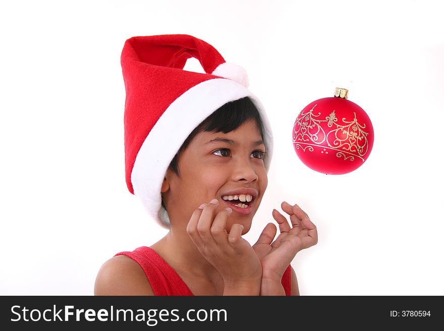 Cute little asian boy as santa claus watching the baubles. Cute little asian boy as santa claus watching the baubles