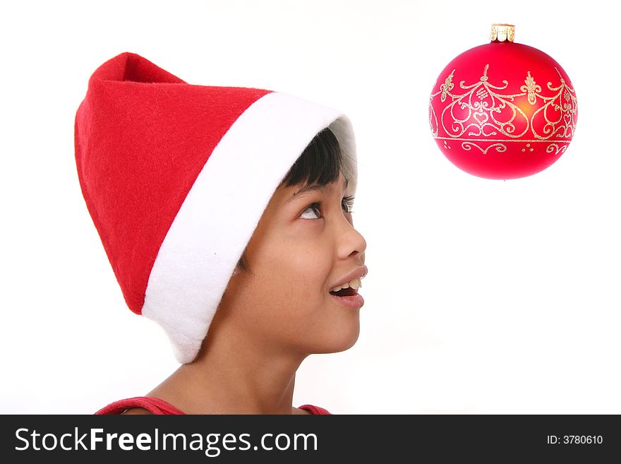 Cute little asian boy as santa claus watching the baubles. Cute little asian boy as santa claus watching the baubles