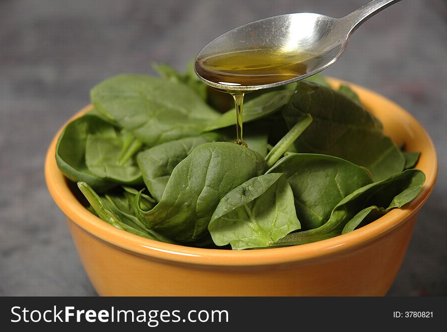 Salad greens with pouring olive oil. Salad greens with pouring olive oil