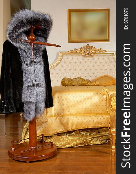 Fur coat on a hanger in a rich bedroom