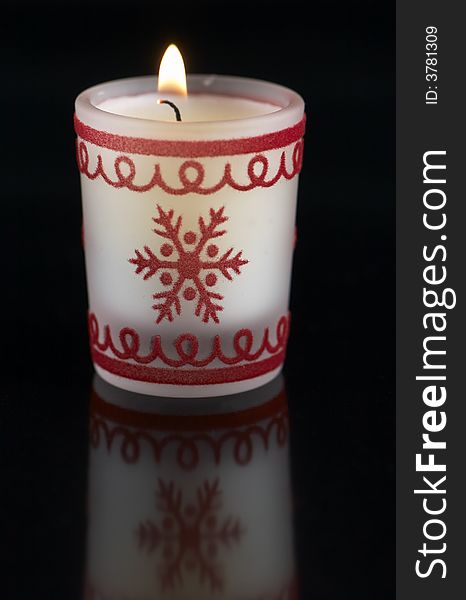 Christmas candle on a reflexion floor