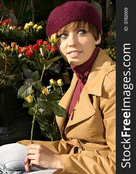 Fashion friendly smiling girl portrait outdoors buying roses.