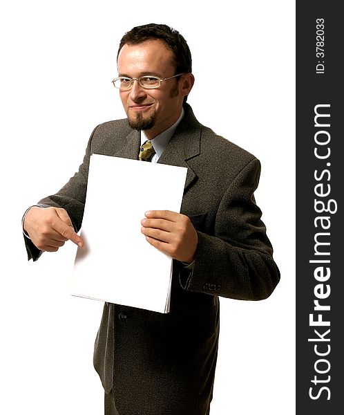 Young handsome businessman pointing to a blank sheet of paper.