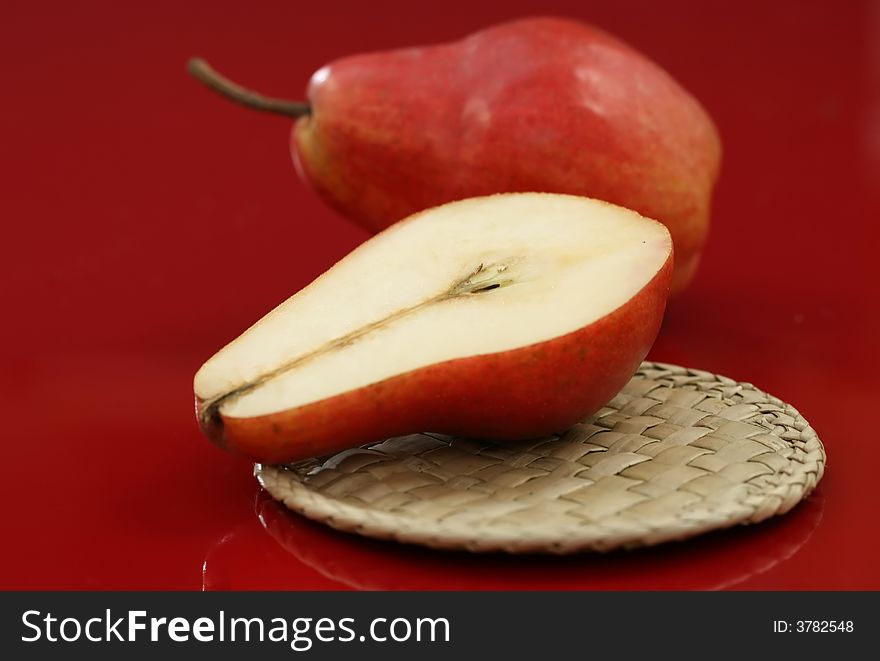Fresh red organic pears on a red background. Fresh red organic pears on a red background