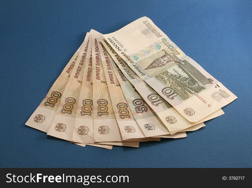 Some Russian cash in a fan shape on a blue background. Some Russian cash in a fan shape on a blue background