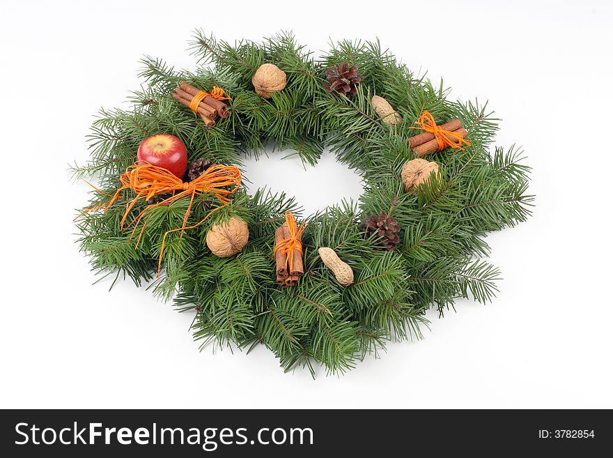 Advent wreath with orange bast, nuts, cones