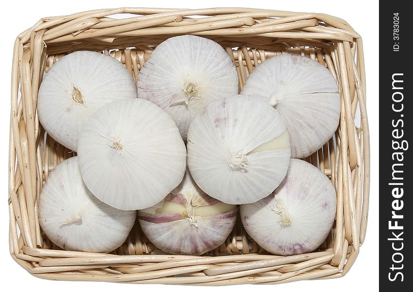 Isolated one clove per head garlic in a basket. Isolated one clove per head garlic in a basket.