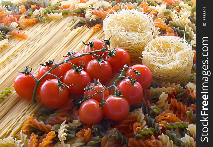 Tomato on different pasta and spaghetti background. Tomato on different pasta and spaghetti background