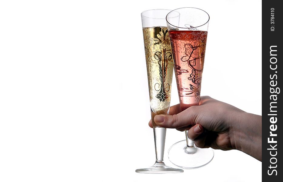 Pair of red and gold champagne flutes making a with bubbles held by hand. Isolated on white space (for text). Pair of red and gold champagne flutes making a with bubbles held by hand. Isolated on white space (for text).