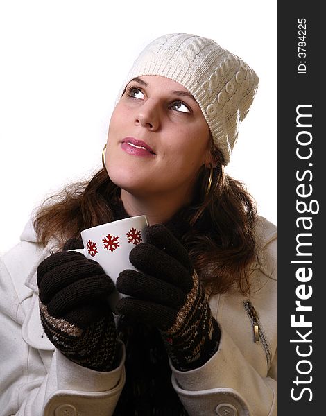 A young woman holding a cup of tea in winterclothes. Isolated over white space (for text). A young woman holding a cup of tea in winterclothes. Isolated over white space (for text).