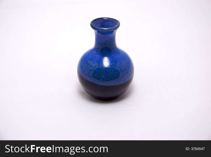A blue ceramic bottle on a white background