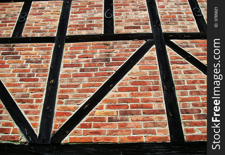 An image of a brick wall with wooden beams. An image of a brick wall with wooden beams