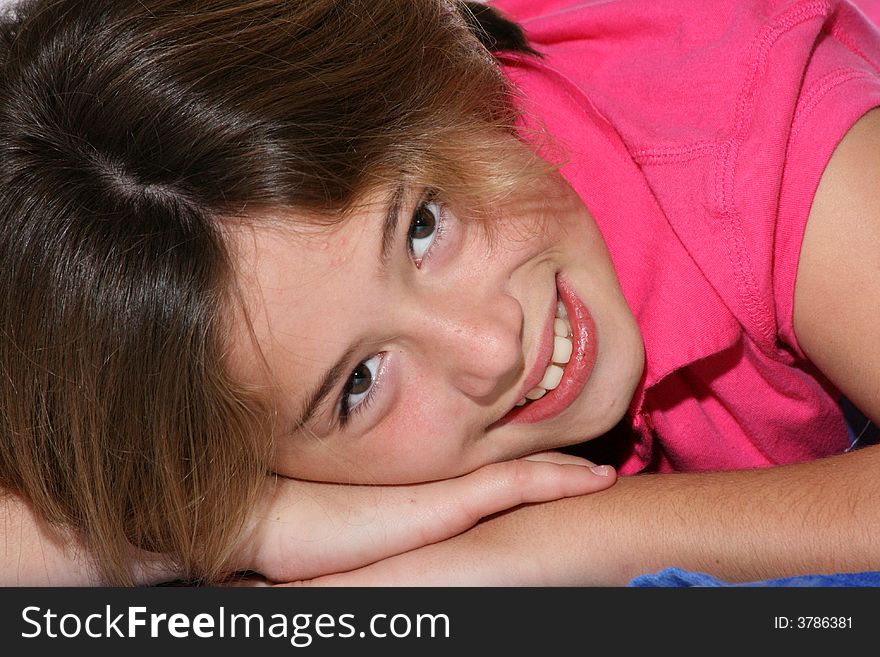 Cute young girl lying with her head on her arms